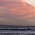 Promeneurs sur la plage du Crotoy en Baie de Somme à marée basse en hiver.